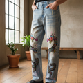 Denim Jeans Featuring a Raw Hem and Colorful Dragon Art with a Faded Sun Effect ODMPOD